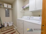 Washer and Dryer. Beach towels are located on the shelf above the dryer.
